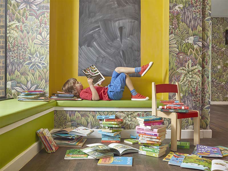 Child lying down reading at Storyhouse